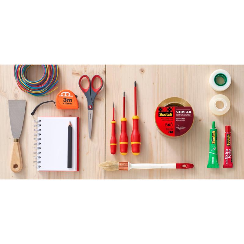 A flat layout shows various tools and aids on wood, including Scotch® packaging tape (50 mm x 66 m) from 3M Deutschland GmbH, scissors, screwdriver, brush, glue, spatula, colored wire, notebook with pencil, and other tapes.