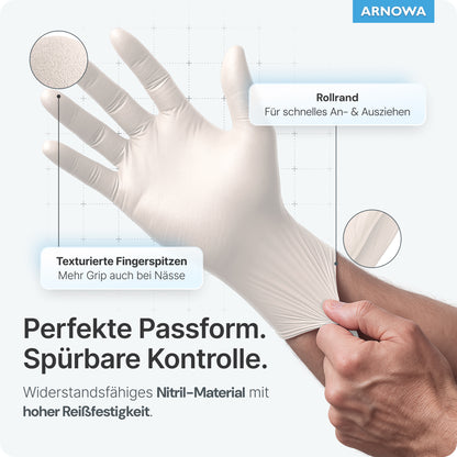 A user puts on ARNOMED NITRIL WHITE tear-resistant disposable gloves from ARNOWA GmbH by pulling on the rolled cuff. Labels show textured fingertips and emphasize its latex-free design, strong grip, and tear-resistant material.