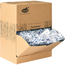 A brown cardboard donation box with the inscription "Duni GmbH Toothpick Neutral Wood 50 | Pack (1000 pieces)" contains individually wrapped wooden toothpicks in white and blue packaging, some of which are visible through the open front flap.