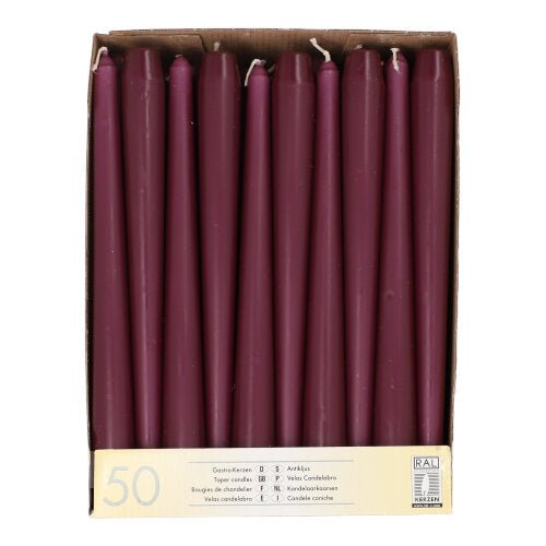 A cardboard box with 50 chestnut-brown, 25 cm long and 2.2 cm thick taper candles, arranged in a single row when viewed from above. The label reads "Starpak 50 Taper Candles Ø 2.2 cm-25 cm" with quantity information in several languages.