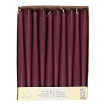 A cardboard box with 50 chestnut-brown, 25 cm long and 2.2 cm thick taper candles, arranged in a single row when viewed from above. The label reads "Starpak 50 Taper Candles Ø 2.2 cm-25 cm" with quantity information in several languages.
