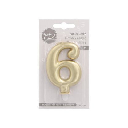 A golden PAPSTAR number candle with holder, shaped as number 6 and 7 cm tall, is in plastic packaging with multilingual labeling, description of the birthday candle, and a Party Greetings logo at the top left. Brand: PAPSTAR GmbH.