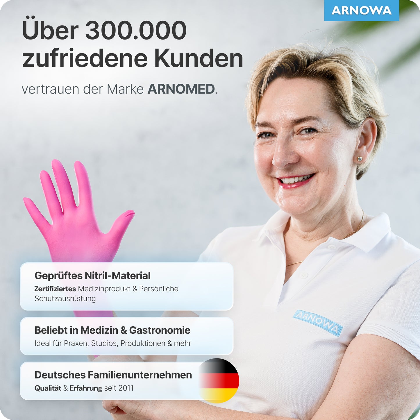 A smiling woman in a white shirt holds up ARNOMED NITRIL MAGNOLIA PINK disposable gloves from ARNOWA GmbH. The text highlights 300,000+ satisfied customers, latex-free, safe for medical/catering, and the German family business.