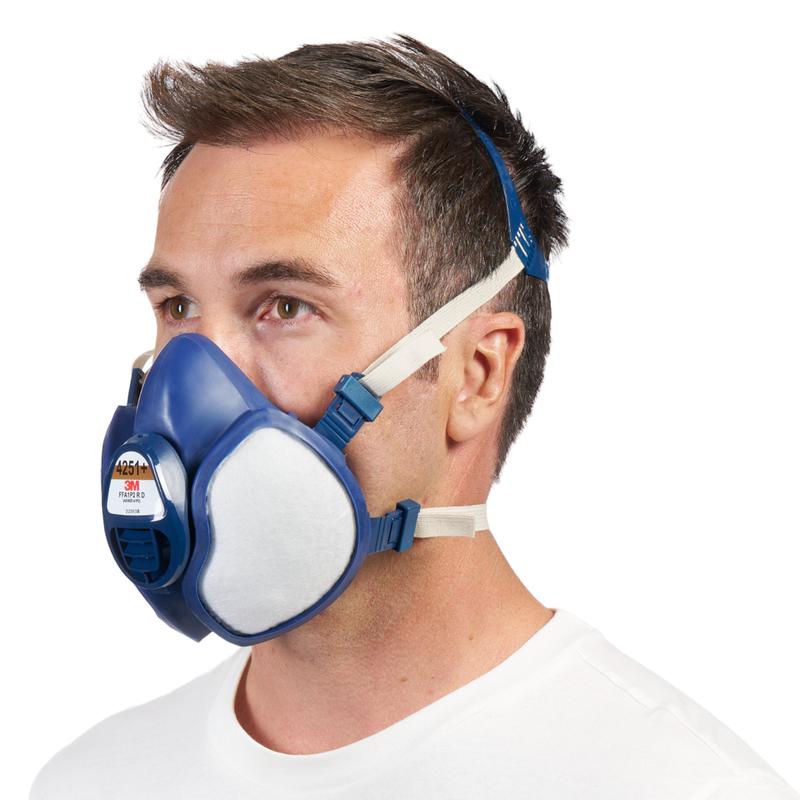 A man in profile wears the 3M™ respirator with integrated filters from 3M Deutschland GmbH in blue and white colors with adjustable headbands against a plain white background.