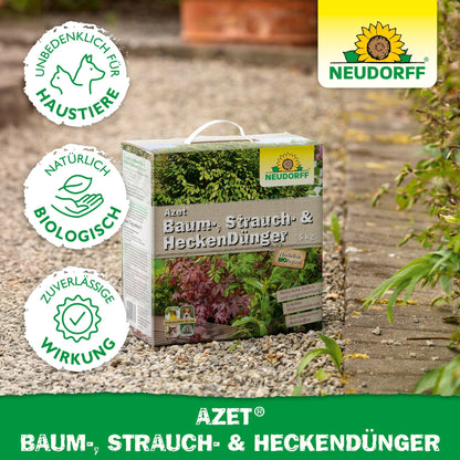 A 5 kg box of Azet Tree, Shrub & Hedge Fertilizer from Neudorff Shop stands outdoors on the garden soil. The image shows logos for animal protection, biological ingredients, and reliable effect as well as clear Neudorff branding. Ideal for shrubs and trees.