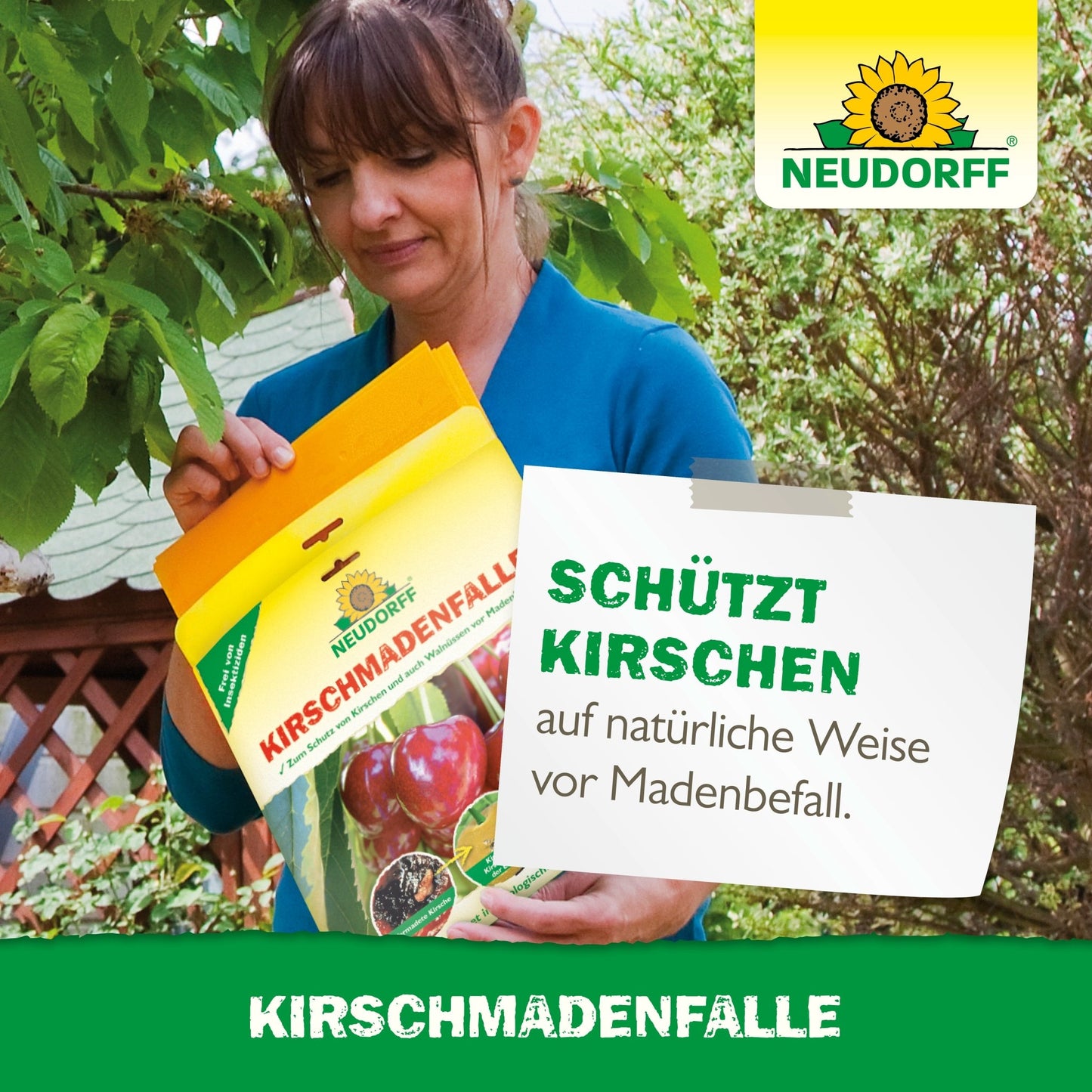 A woman holds a Neudorff Shop cherry maggot trap outdoors to protect cherries from the cherry fruit fly. Behind her are a tree and a wooden structure. The German text explains the use for cherries.
