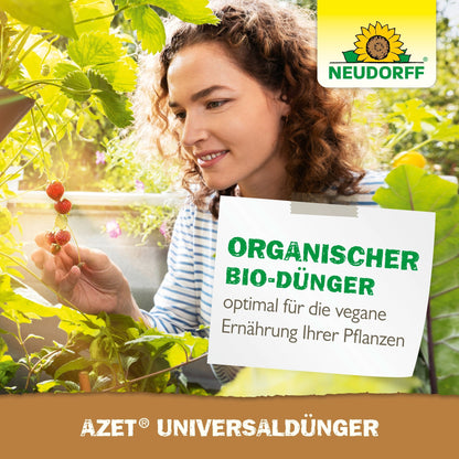 A woman inspects strawberry plants in a lush garden where Neudorff Shop's Azet Universal Liquid Fertilizer is used—a vegan liquid fertilizer with optimal nutrients for all plants. The German text emphasizes universal application and balanced nutrition.
