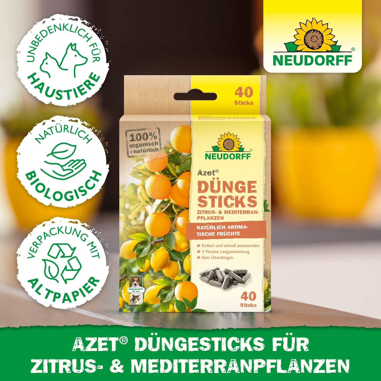 Depicted is a package of Neudorff Shop Azet fertilizer sticks for citrus & Mediterranean plants with symbols for animal protection, organic quality, and recyclable packaging. In the background, lemons and green leaves can be seen.