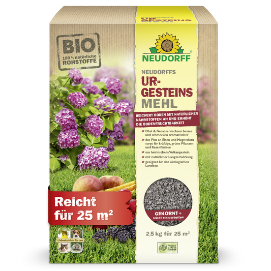 A box of Neudorff's UrgesteinsMehl from the Neudorff Shop stands upright and displays pictures of hydrangeas, apples, and grass. The 2.5 kg package is sufficient for 25 m² and is intended to improve soil fertility.
