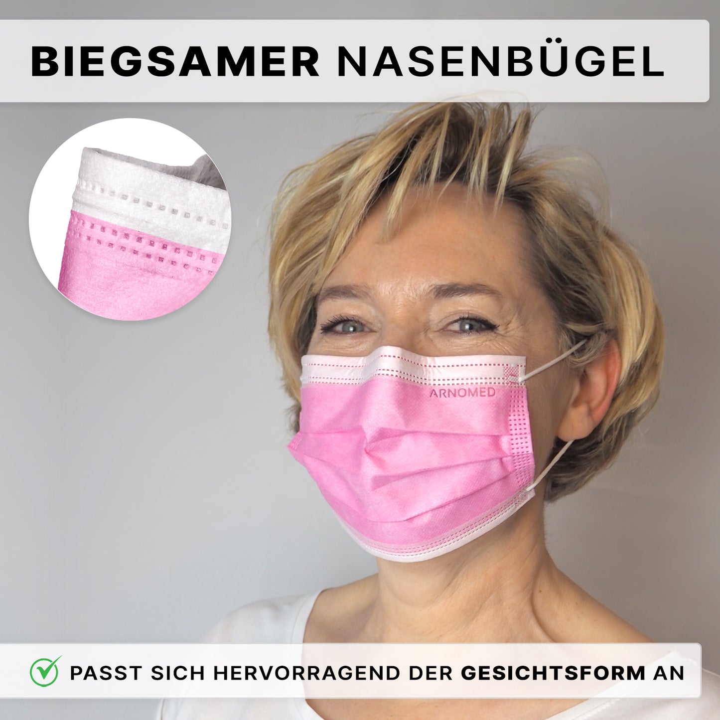 A person with short blonde hair wears the ARNOMED MUNDSCHUTZ TYPE IIR surgical mask with elastic bands Type IIR from ARNOWA GmbH in pink, which impresses with its flexible nose clip and perfect fit. An insert highlights the detail of the nose bridge, the German text emphasizes the fit.