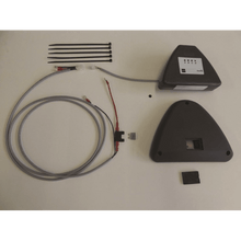 The IntelliTrail - mounting kit for swingo 350/455 from Diversey Deutschland GmbH & Co. OHG contains a black device with a cable, a triangular cover, four cable ties, a long gray cable with plugs, and a small fuse on a white base.