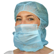 A person wearing the ARNOMED COVER PP-ASTROHAUBE WITH 2-LAYER MOUTH PROTECTION from ARNOWA GmbH, in blue, and a blue disposable beard cover stands against a white background.