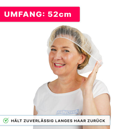Smiling woman wears ARNOMED COVER PP-BARETTHAUBE made of PP non-woven fabric by ARNOWA GmbH and holds one side. Pink flag: "CIRCUMFERENCE: 52cm." Text: "Reliably keeps long hair back - ideal for the hygiene sector."