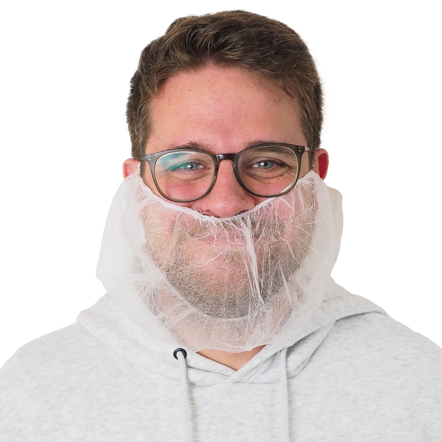 A man with glasses and a light gray hoodie is wearing an ARNOMED PP beard protector White, with elastic band, disposable (ARNOWA GmbH) over his mouth and chin. The background is solid white.