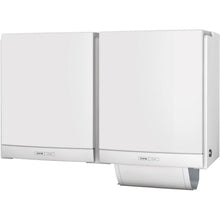 Two white CWS ParadiseLine fabric towel dispensers DUO with white panel are mounted side by side and provide an eco-friendly and hygienic solution for washrooms. A towel is visible in the eco-friendly unit.