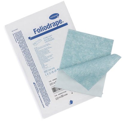 A package of Paul Hartmann AG Foliodrape surgical adhesive strips 10x50 (package, 115 pieces) lies next to two unfolded blue and white cloths for securing surgical drapes in sterile operating environments.