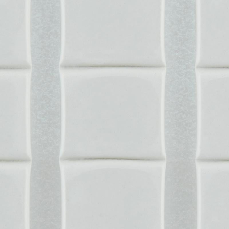 Close-up of white, glossy, rectangular tiles with slightly raised edges, arranged vertically with thin grout lines - securely fastened with 3M Deutschland GmbH Scotch-FIX™ Removable Adhesive Pads 301008C36-P (11 mm x 15 mm, 36 pieces/pack).