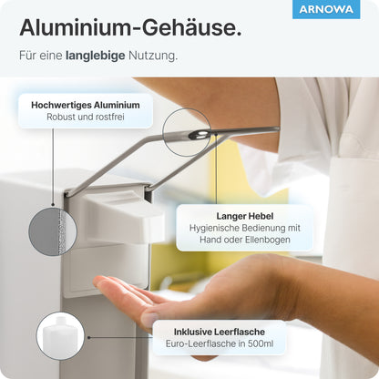 A person presses the long lever of the ARNOWA GmbH ARNOMED DISPENSER with their elbow and dispenses soap or disinfectant into the open hand. This manual wall dispenser is made of robust aluminum, features a hygienic design, and comes with an empty 500 ml bottle.