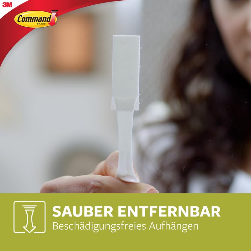 A person holds a white Large Command™ Picture Hanging Strip L from 3M Deutschland GmbH (6 sets, value pack, 17206-6). The image shows the Command logo and the text: "Cleanly removable. Damage-free hanging."