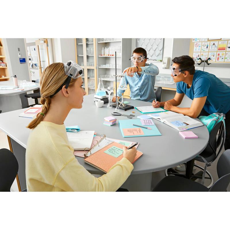 Three students with safety goggles work together at a lab table. While one adjusts the equipment, the others take notes with Post-it® Super Sticky Notes (47.6 mm x 47.6 mm, 90 sheets/block, 100% PEFC) from 3M Deutschland GmbH.