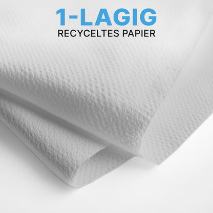Close-up of two white ARNOMED PAPER TOWELS (25 x 23 cm, V-FOLD) from ARNOWA GmbH with a textured surface, layered in V-fold. The blue-black text reads "1-PLY RECYCLED PAPER" - ideal for washrooms.