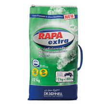 Pictured is a 12 kg bag Dr. Schnell RAPA EXTRA laundry disinfection manual dosing by DR.SCHNELL GmbH & Co. KGaA is depicted. The green packaging emphasizes the suitability for professional laundry disinfection through manual dosing.