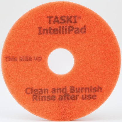 The TASKI Intellipad Combined Cleaning and Polishing Pad for maintenance cleaning from Diversey Deutschland GmbH & Co. OHG is an orange, round pad with a center hole and black lettering - ideal for daily cleaning and polishing.