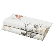 A folded piece of fabric with a nature-inspired design of leaves and flowers in shades of red, brown, and beige reflects the elegance of a Duni Bio Dunisoft® napkin. Suitable for home decoration like curtains or upholstery.