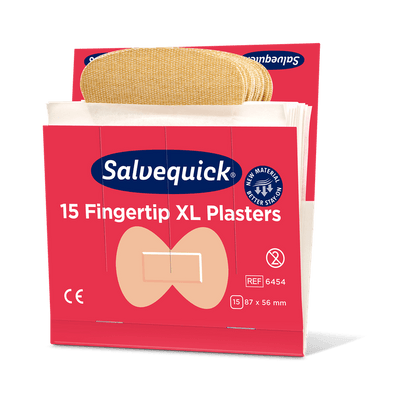 An opened box of Orkla Wound Care AB XL Fingertip Textile Plasters, 15 pieces/mine (pack of 6 pieces), shows beige fingertip plasters. The red box measures 87 x 56 mm and highlights the flexible design of the textile plaster.