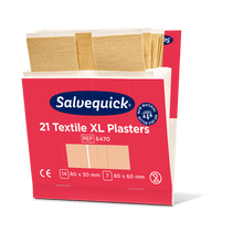 A pink-white box from Orkla Wound Care AB labeled "Xl textile plaster, 21 pieces/mine | Package (6 pieces)" contains large fabric plasters in two sizes: 80x30 mm and 80x60 mm. Several beige plasters can be seen on top of the open box.