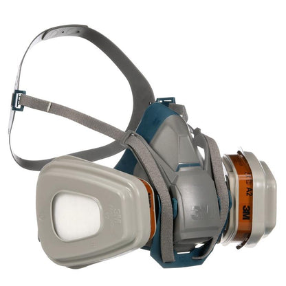 A gray and blue 3M™ Quick Latch Respirator 6502QLKIT-1 with adjustable rubber straps and replaceable A2P3 filters (2x6055, 2x5935, 2x501) from 3M Deutschland GmbH for protection against organic vapors.