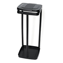 The Nölle Profi Brush waste bag stand for 120-liter bags, black, by Nölle Profi Brush Bürsten- & Pinseltechnik e.K. features a black, open frame with a square base, four vertical rods, and a flip-open lid for convenient waste collection.