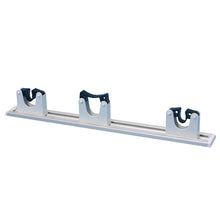 The hanging rail from Diversey Deutschland GmbH & Co. OHG (package, 1 piece) is a horizontal metal holder with three U-shaped plastic holders for securely mounting brooms or mops on the wall.