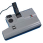 The TASKI electric vacuum brush 230V 38mm from Diversey Deutschland GmbH & Co. OHG is a gray suction head with a black nozzle, round scale, cable, and two control lights (red/green) on the top. Packaging: 1 piece. Power supply: 230V.