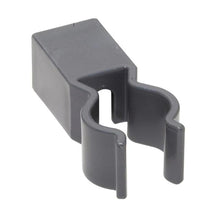 The TASKI holder for bag storage from Diversey Deutschland GmbH & Co. OHG is a grey plastic clip with a rectangular base and U-shaped opening, designed for attachment to aluminum profiles in waste disposal and features gentle curves for holding cylindrical objects.