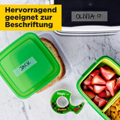 A sandwich container labeled "JACK", a fruit container, and the 3M Scotch® Magic™ Invisible Tape (3 rolls, 19 mm x 25 m + 1 free hand dispenser) are on the table. A lunch box labeled "OLIVIA" is partially visible.