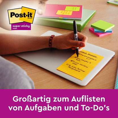 On a closed laptop, someone writes a list on a Post-it® Super Sticky Notes in large format, lined (101mm x 152mm) from 3M Deutschland GmbH; more colorful sticky notes lie on the table. Great for listing tasks and to-do's.