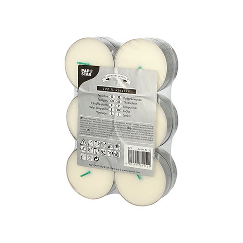 A transparent, shrink-wrapped pack of 12 white PAPSTAR Maxi tealights (Ø 59 mm, 100% stearin) is equipped with green wicks, safety symbols, product information, and the logo of PAPSTAR GmbH to highlight the long burning time.