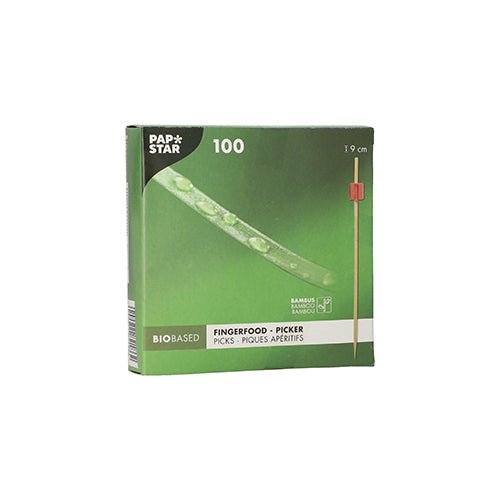 The green box "PAPSTAR 100 Fingerfood - Picker" by PAPSTAR GmbH contains 100 bamboo picks each 9 cm long. The bio-based packaging shows a pick with a red tip, ideal for serving finger food skewers at any event.