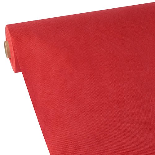 A large roll of Starpak tablecloth, fabric-like fleece “Soft Selection”, is partially rolled out on a white surface, showing its smooth texture, even color, and appealing thickness, characteristic of the Starpak brand.