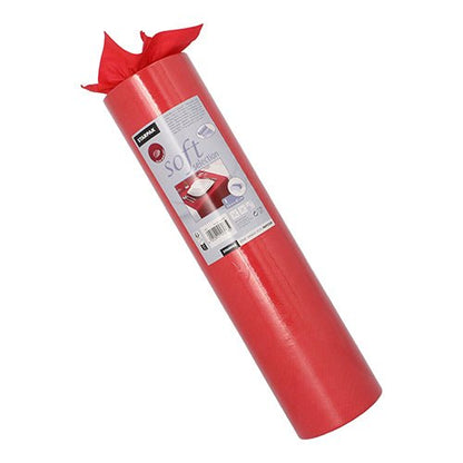 A roll of Starpak table runner, fabric-like fleece "soft selection" (24 m x 40 cm), stands upright. The label shows product information and wrapped gifts, while the soft runner is partially unrolled at the top.