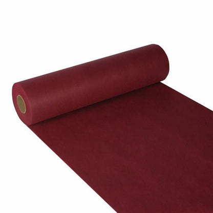 A partially unrolled Starpak table runner, fabric-like fleece "soft selection" (24m x 40cm), in dark red, is depicted on a white background with a smooth, matte surface - ideal for stylish decoration. The paper is wrapped around a cardboard core.