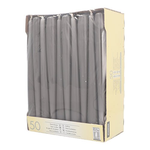 In a partially visible beige box with a clear window are upright-standing Starpak 50 taper candles Ø 2.2 cm - 25 cm, white candles known for their long burn time.