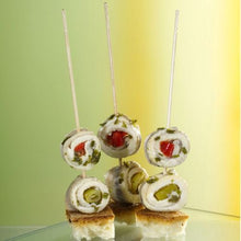 Three rolled fish fillet skewers stand upright on bread cubes, presented as PAPSTAR finger food picks "pure" 15 cm (turned, elegant) from PAPSTAR GmbH - ideal for stylish catering events.