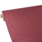 A roll of Starpak tablecloth, fabric-like, fleece "soft selection plus" by Starpak in a textured reddish-brown shade is partially unrolled on a white background, highlighting the surface texture and color of the material.