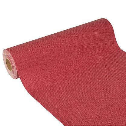 The Starpak table runner made of fabric-like nonwoven 'Soft Selection Plus' (24 m x 40 cm) is partially visible on a white background - its slightly rough texture and diagonal alignment lend elegance to the image.
