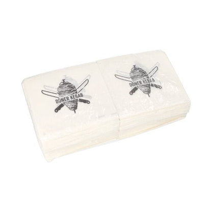 A stack of PAPSTAR doner kebab bags (16x16 cm, greaseproof), each with a doner skewer and crossed knives as on the napkins, packed in shrink wrap (1000 pieces) from PAPSTAR GmbH.