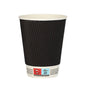A black Starpak 25 drinking cup “To Go” Ripple Wall cup with a ribbed exterior, white interior, and a label near the bottom with recycling and warning symbols stands upright empty against a white background.
