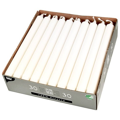 A box of 30 PAPSTAR taper candles (Ø 2.2 cm, white, 100% stearin) from PAPSTAR GmbH, neatly arranged in three rows in a partially opened cardboard packaging with uniform taper candles and visible wick.