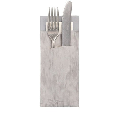 A silver fork and knife rest in a PAPSTAR 520 cutlery bag (20x8.5cm, 2-ply) with an integrated matching napkin from PAPSTAR GmbH, handles protrude and the napkin is partially visible behind.